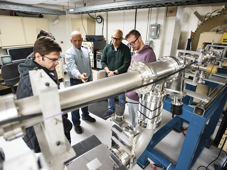 UNT physics professor Bibhudutta Rout (middle) and his students conduct radiation ground testing on solar cells