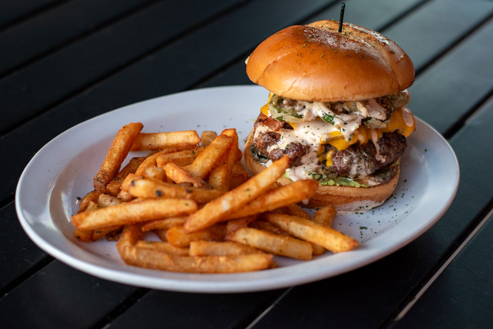 Burger and fries on a plate.