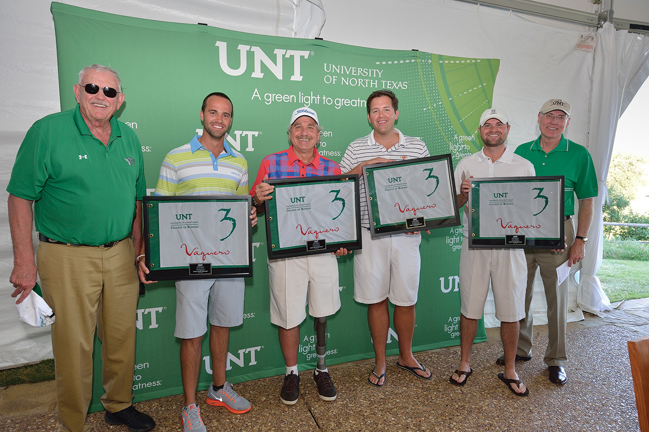 Golfers holding awards