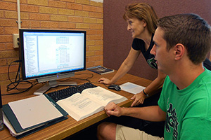 Justin Martin, a UNT student, and Margie Tieslau, associate professor of economics, are on a team of people collaborating with Our Daily Bread to design a statistical model that can better forecast how many meals the community soup kitchen will need to prepare each day.