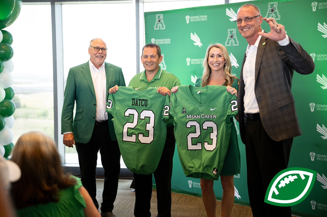 President Neal Smatresk and Athletics Director Jared Mosely pose with DATCU officials, CEO Glen McKe