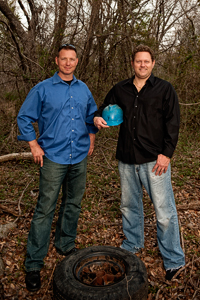 Tim Sommers (’98) and Eric Baumgart work to clean up scrap tire materials from illegal tire dumps through their environmental cleanup company TERC LLC. (Photo by Angilee Wilkerson)