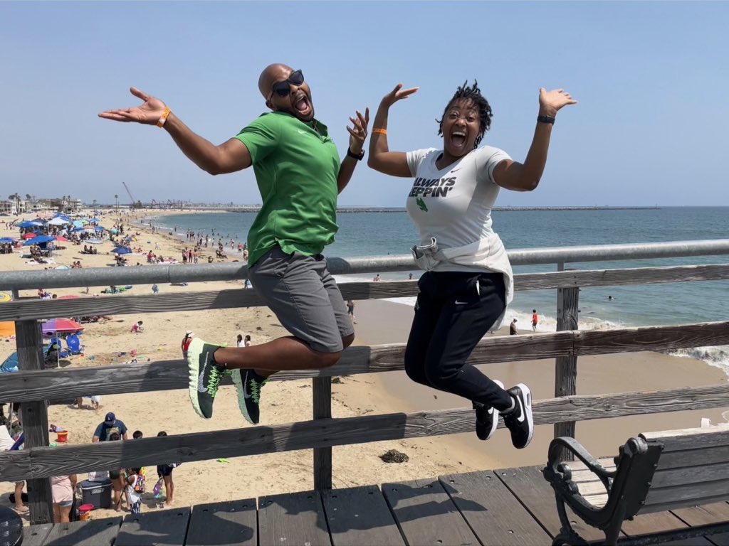 Photo of Jalie Mitchell and Durmon Jennings jumping at Seal Beach California