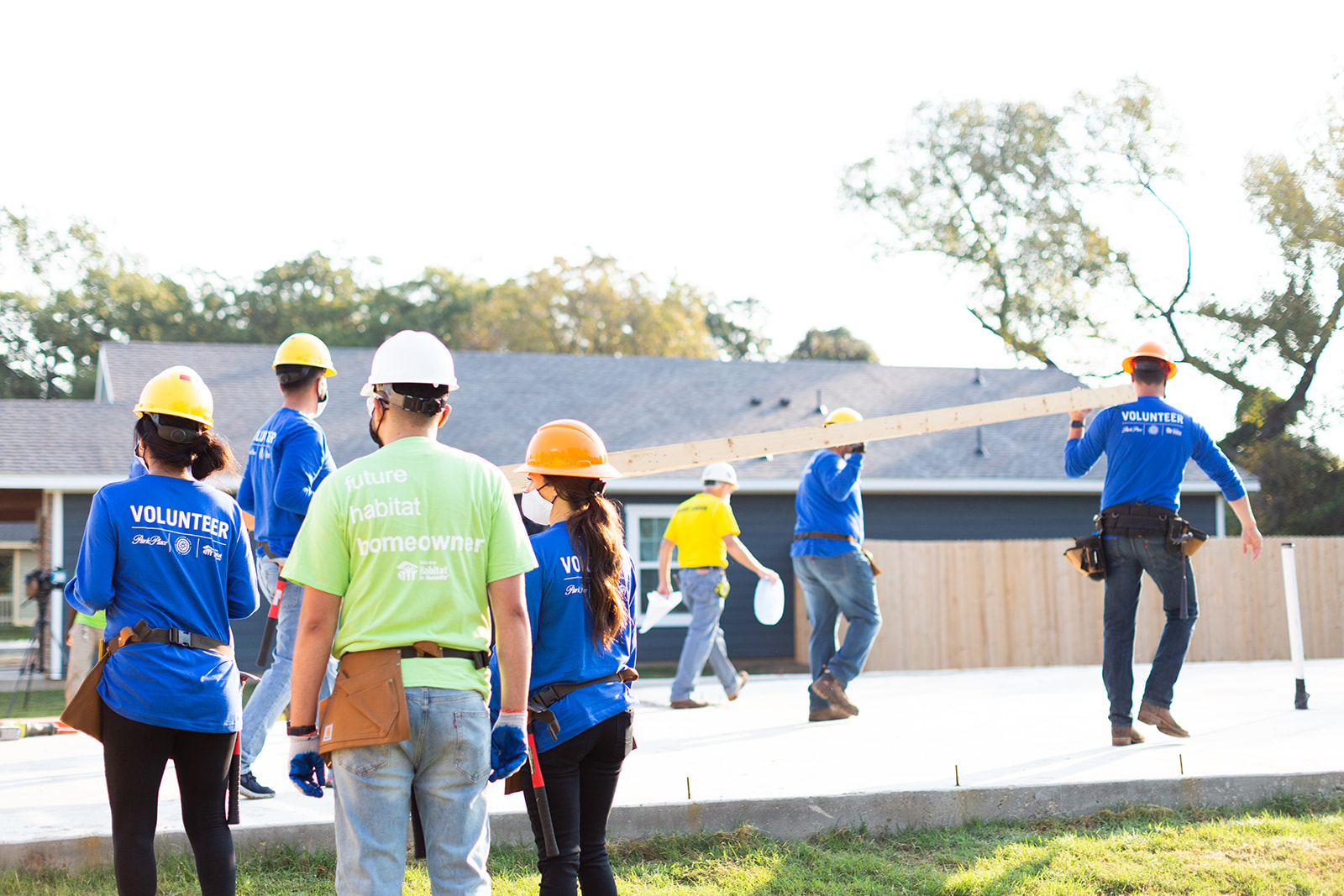 Photo of people working at house construction site