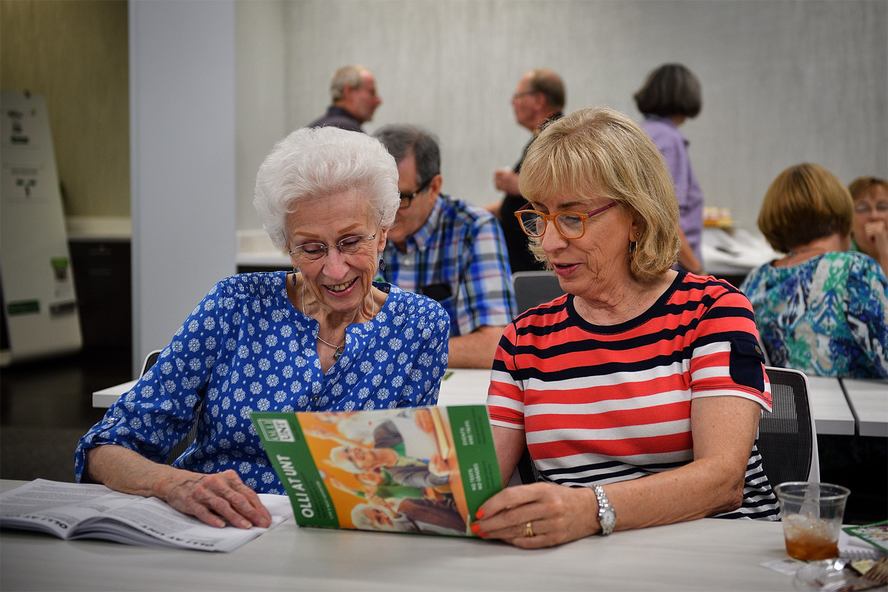 Two women at desk reading