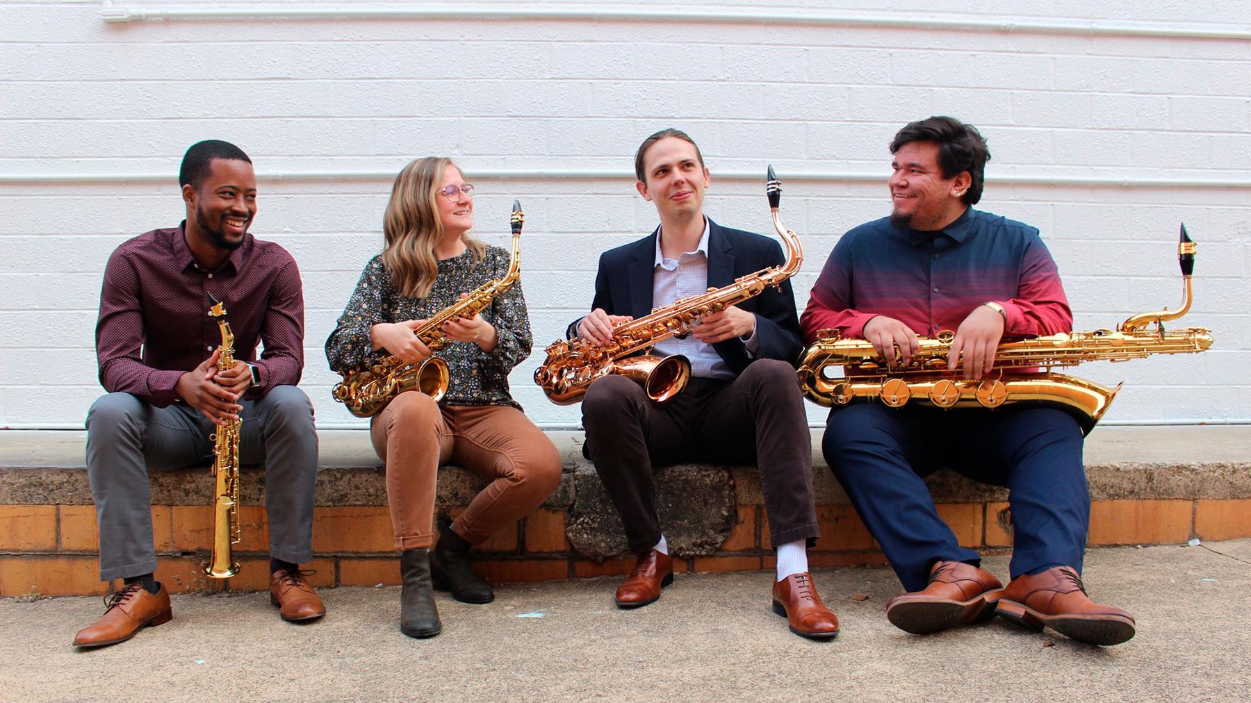 Lotus Quartet members sitting with their instruments